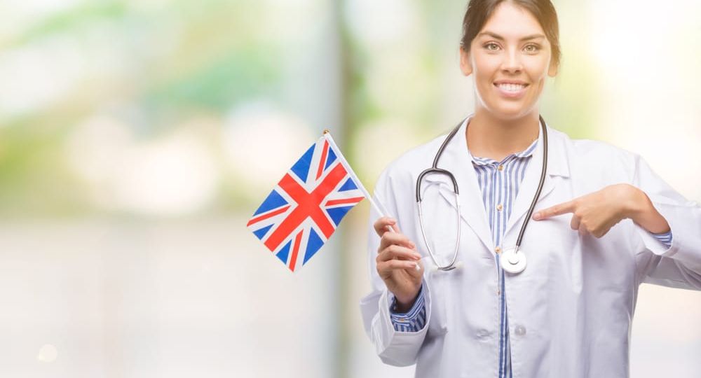 Young,Hispanic,Doctor,Woman,Holding,Flag,Of,United,Kingdom,With